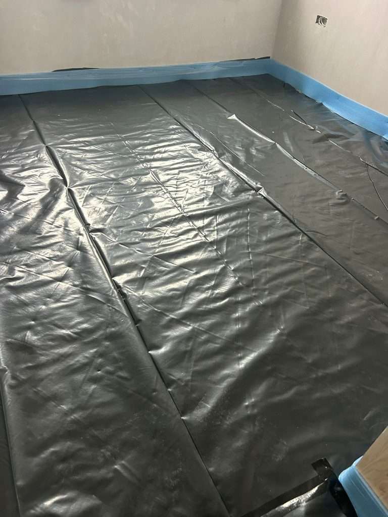 Polythene membrane laid over the floor ahead of the screed
