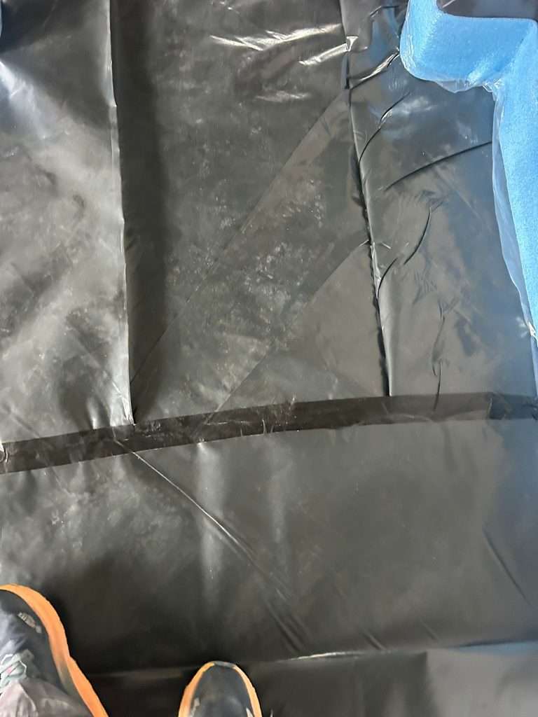 Close-up of taped polythene membrane prepared for floor screed