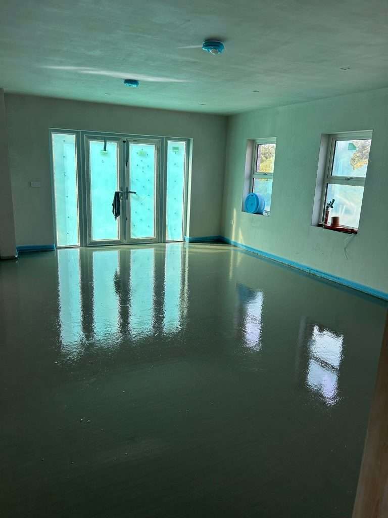 Freshly poured Liquid Screed in a room with French doors