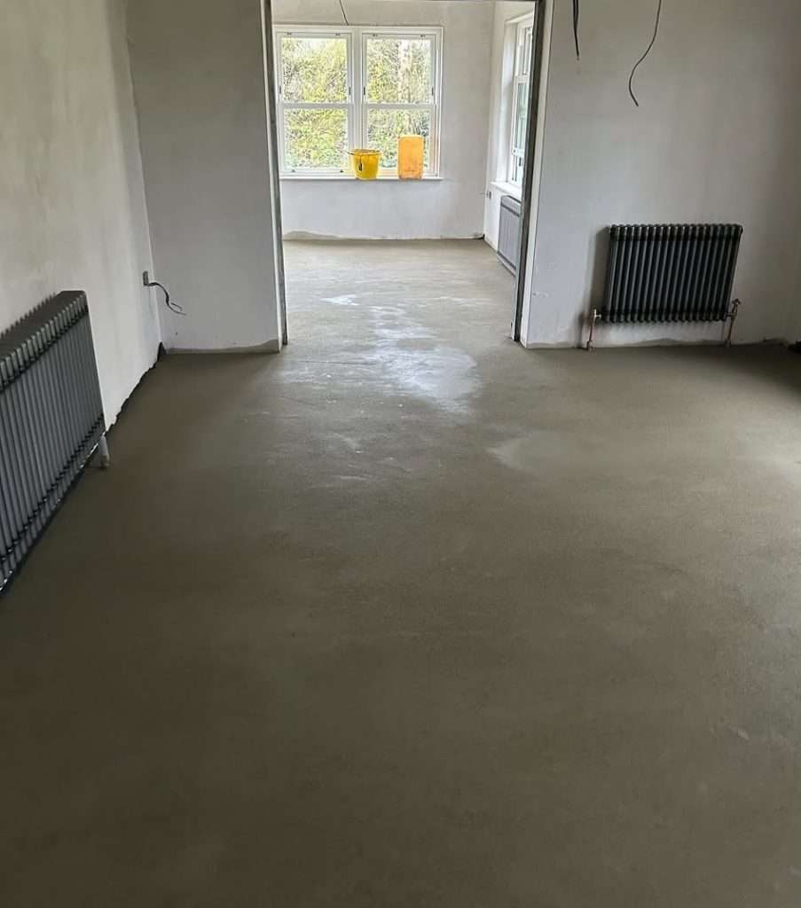 Sand and Cement Screed laid through a room with radiators and a bay window